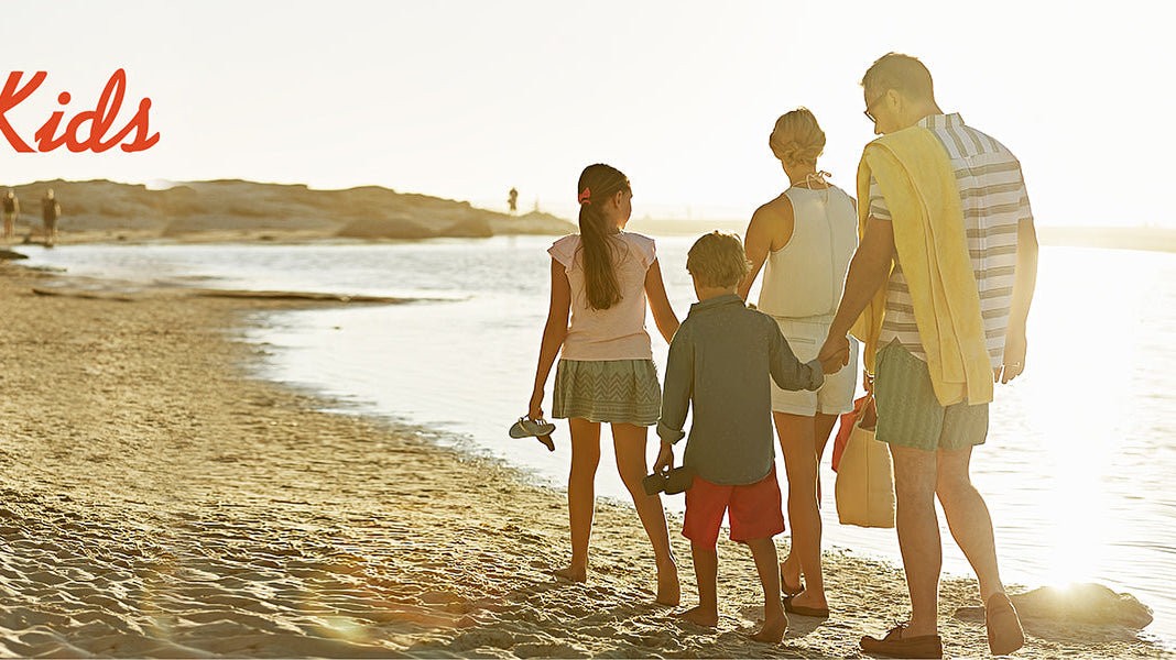 boy wearing bright blue kids swim trunks running on the beach