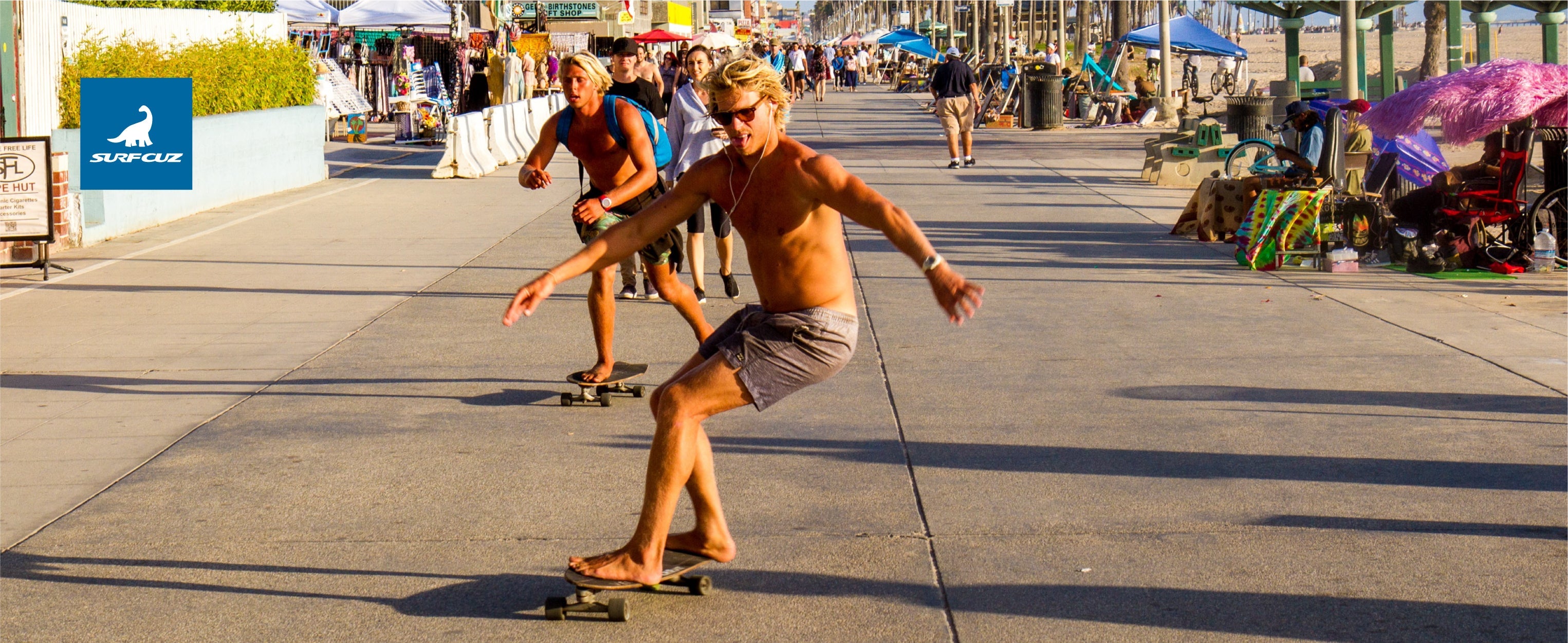 Man wearing quick-dry men's swim trunks while walking from the beach to the city in summer 2025