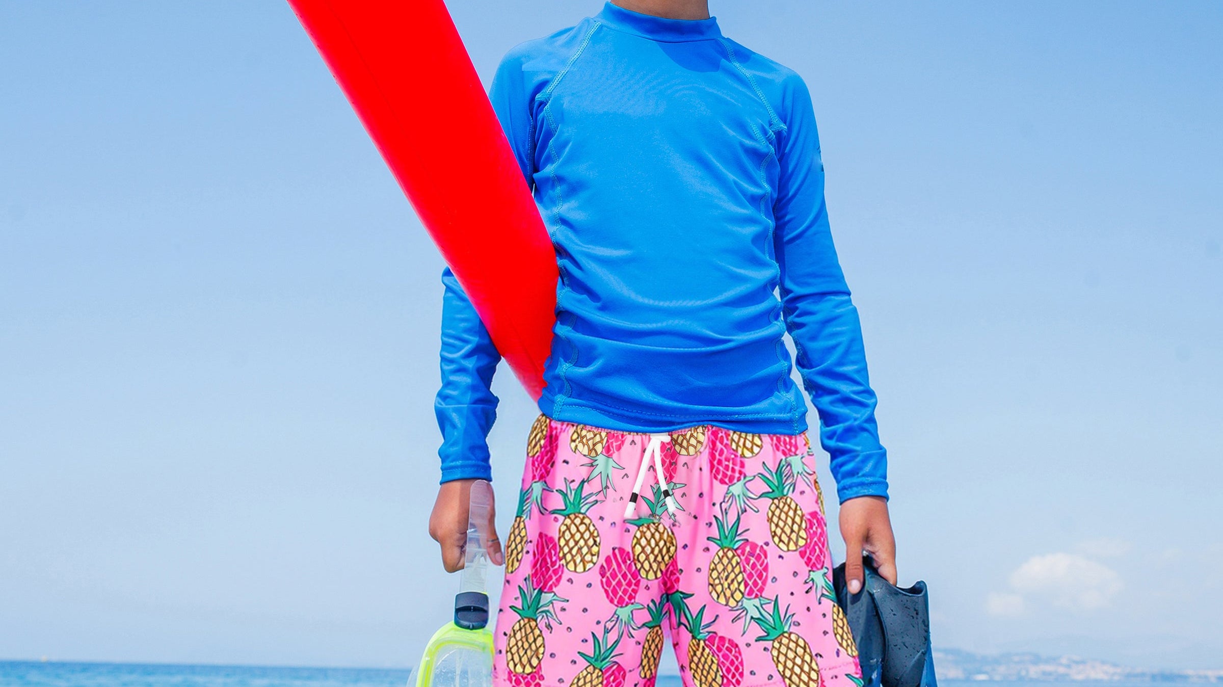 Young boys wearing Surfcuz boys beach shorts on family vacation — quick-dry, versatile, and perfect for swimming, playing, and traveling.