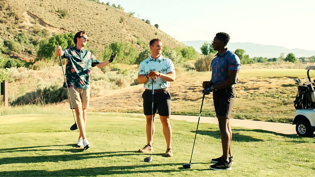 an wearing a light blue men's performance polo shirt while walking along a marina