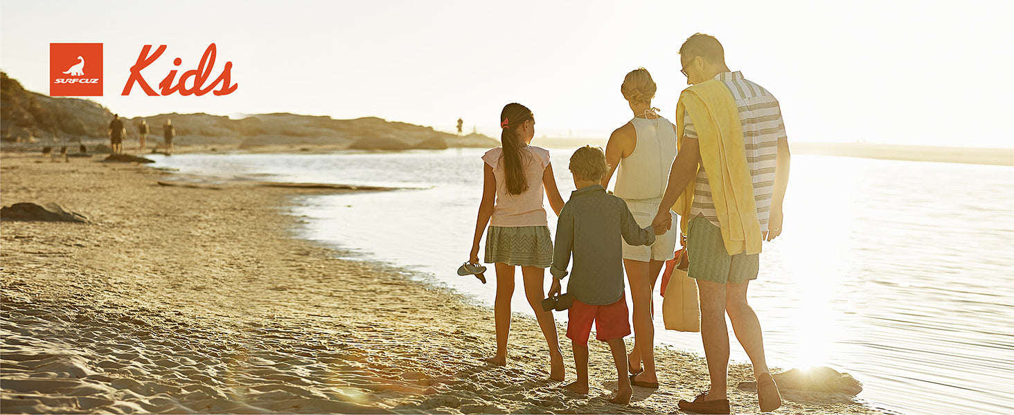 boy wearing bright blue kids swim trunks running on the beach