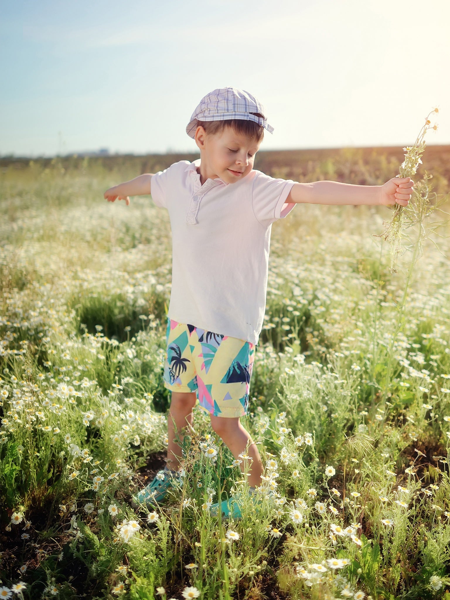 Happy child wearing Surfcuz kids swim trunks at the beach, showing comfort, style, and versatility for summer play.
