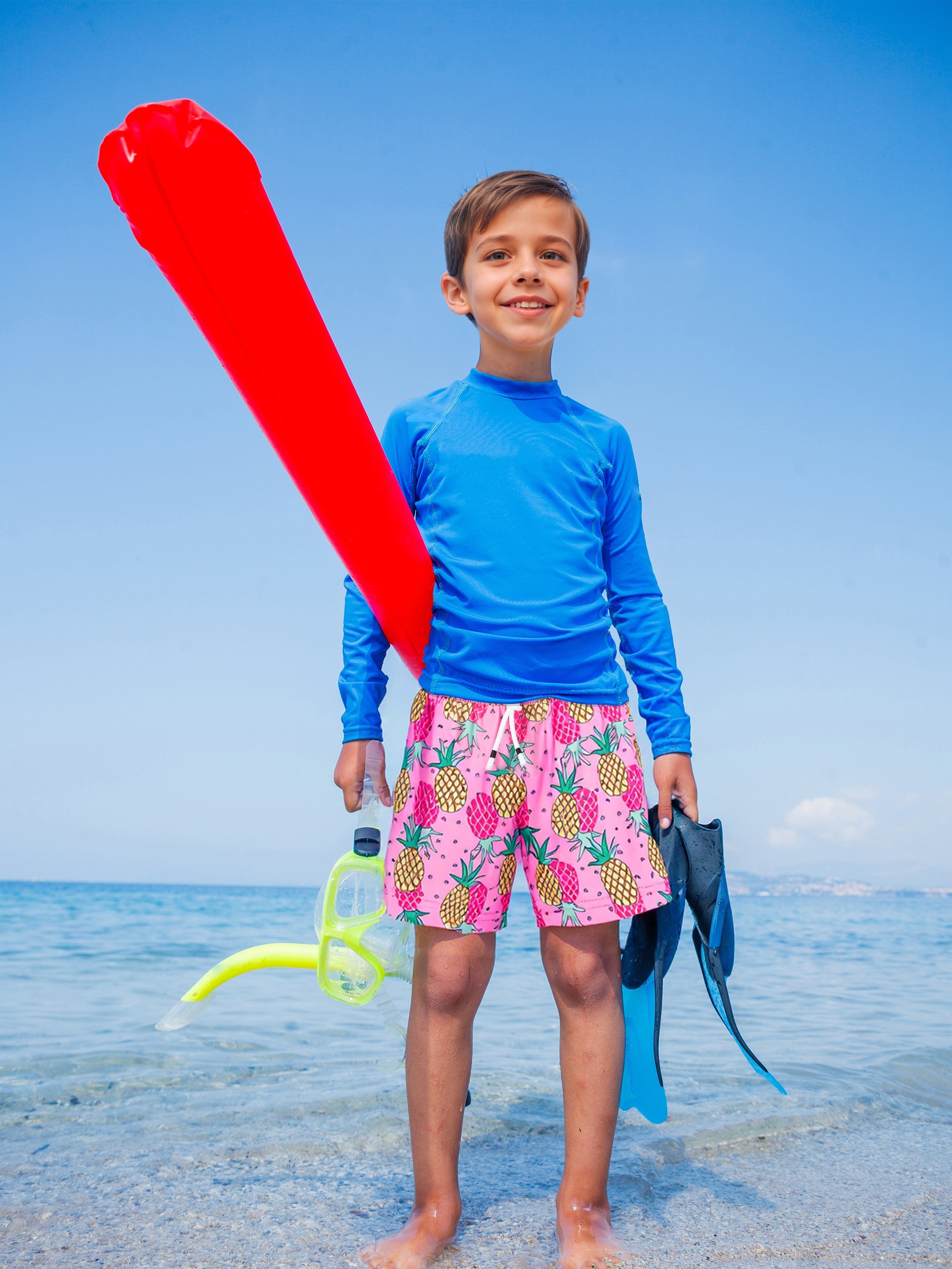 Young boys wearing Surfcuz boys beach shorts on family vacation — quick-dry, versatile, and perfect for swimming, playing, and traveling.